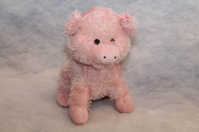 Zottelplüschschwein sitzend